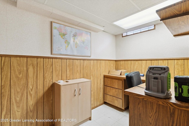 home office with wood walls and a wainscoted wall