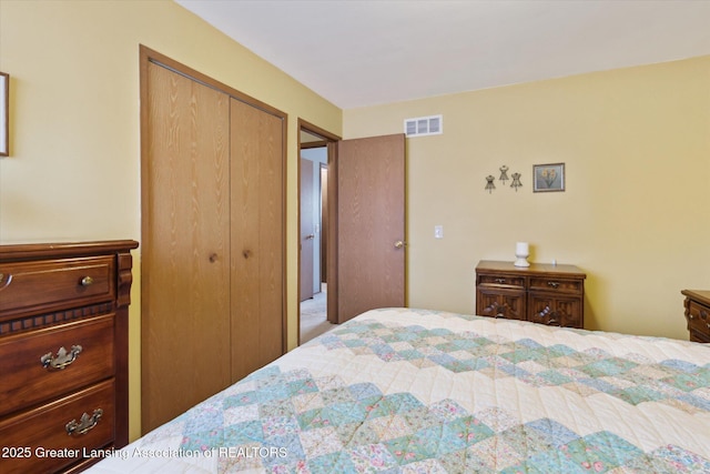 bedroom with visible vents and a closet