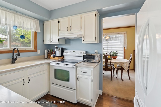 kitchen featuring white appliances, a toaster, under cabinet range hood, a sink, and white cabinetry