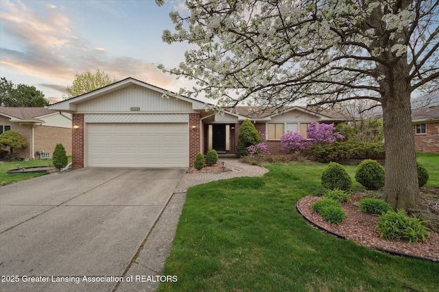 single story home featuring brick siding, a front yard, concrete driveway, and an attached garage