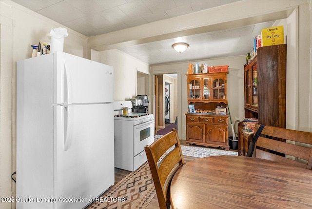kitchen featuring white appliances, light wood-style floors, and brown cabinets