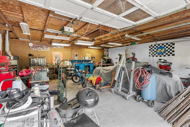 garage with a workshop area and a garage door opener