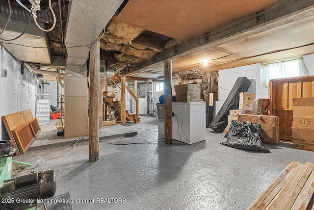 basement featuring healthy amount of natural light, stairway, and heating unit