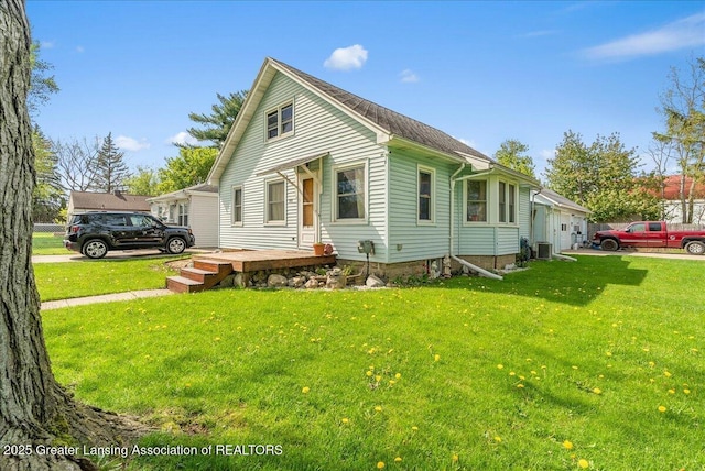 view of front of property featuring a front lawn and central air condition unit