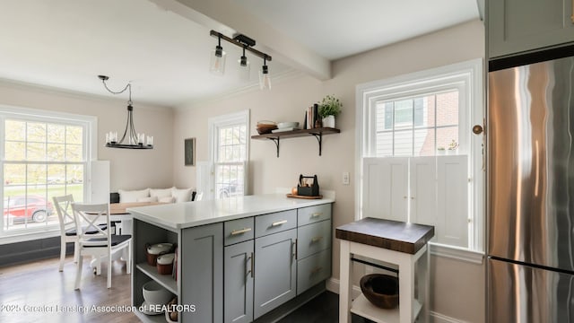 kitchen with open shelves, dark wood-style floors, freestanding refrigerator, gray cabinets, and hanging light fixtures