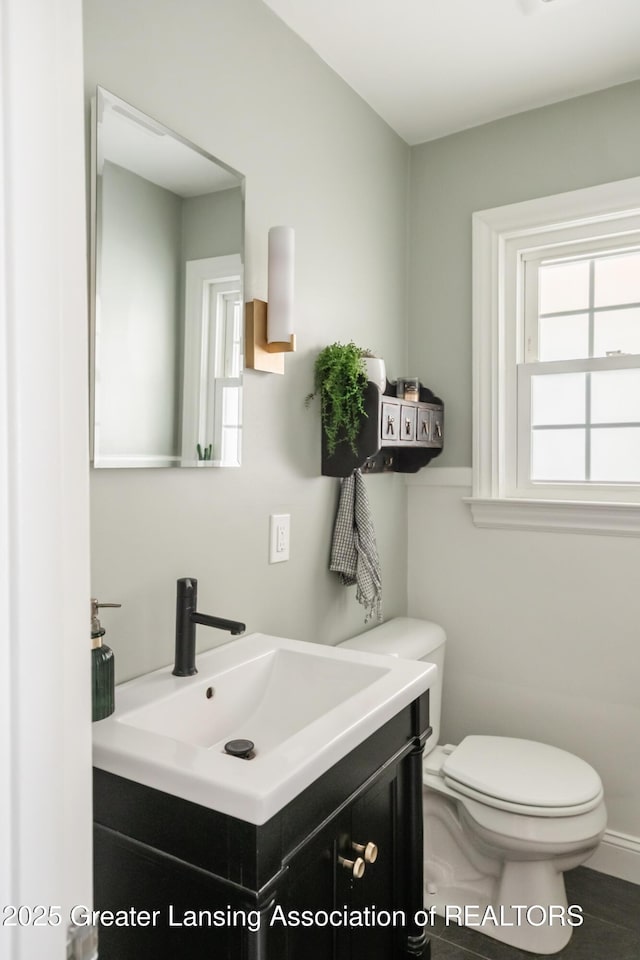 bathroom featuring toilet and vanity