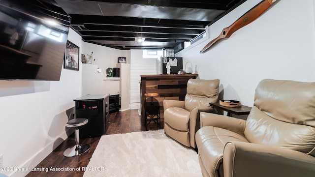 living area with wood finished floors and baseboards
