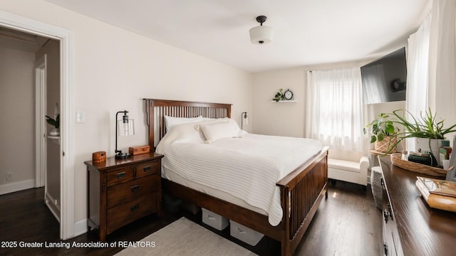 bedroom featuring dark wood finished floors
