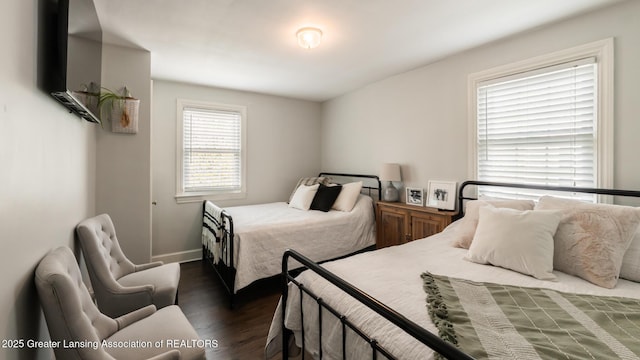 bedroom featuring dark wood finished floors and baseboards