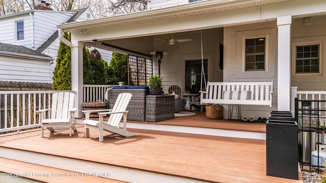 deck with ceiling fan and covered porch