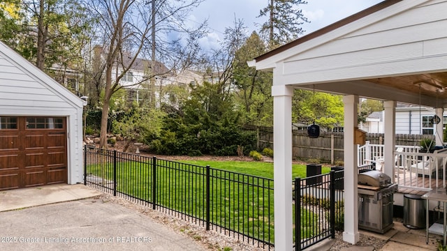 exterior space with concrete driveway, a garage, and fence private yard