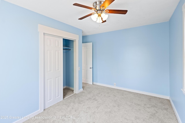 unfurnished bedroom with a closet, baseboards, and carpet flooring