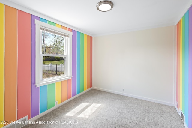 carpeted spare room featuring baseboards and wallpapered walls