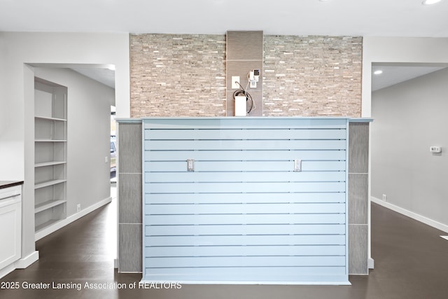 room details featuring recessed lighting, baseboards, built in features, and wood finished floors