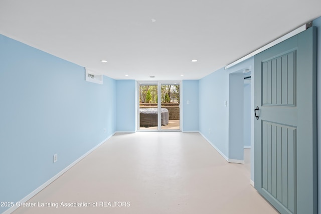 interior space featuring recessed lighting, finished concrete flooring, baseboards, and visible vents