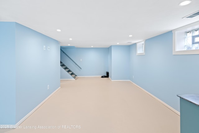 below grade area with recessed lighting, visible vents, and stairway