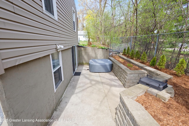 view of patio featuring fence