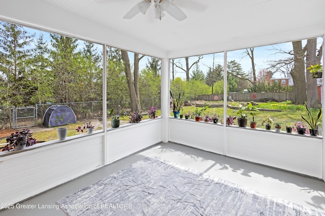 unfurnished sunroom featuring ceiling fan