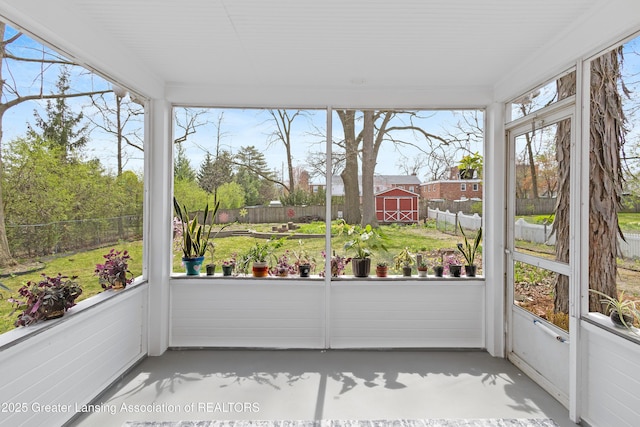 unfurnished sunroom with finished concrete flooring
