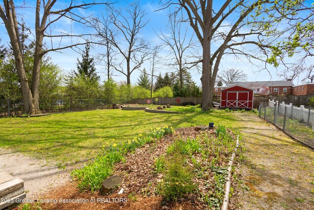 view of yard with a fenced backyard and an outbuilding