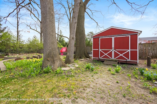 view of shed featuring fence