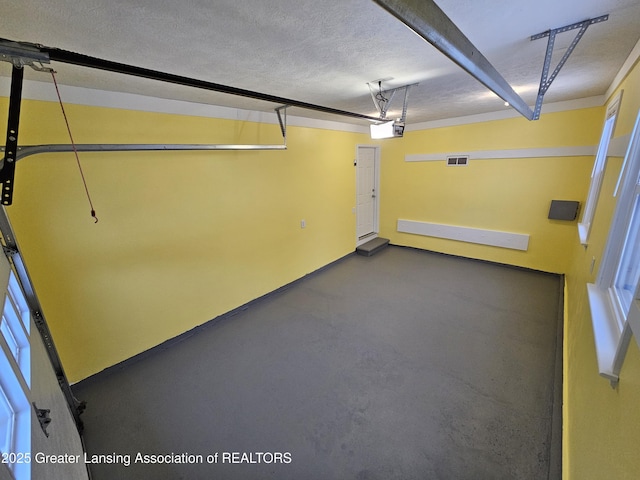 garage with visible vents and a garage door opener
