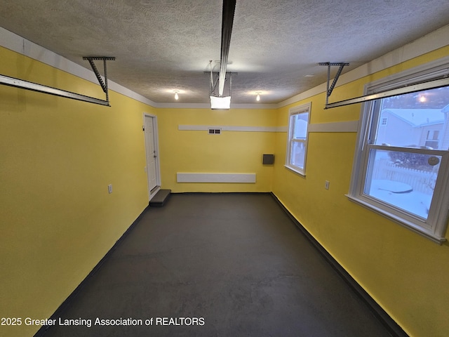 garage with baseboards and visible vents