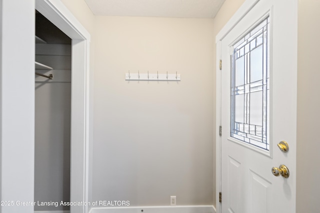 doorway to outside with baseboards