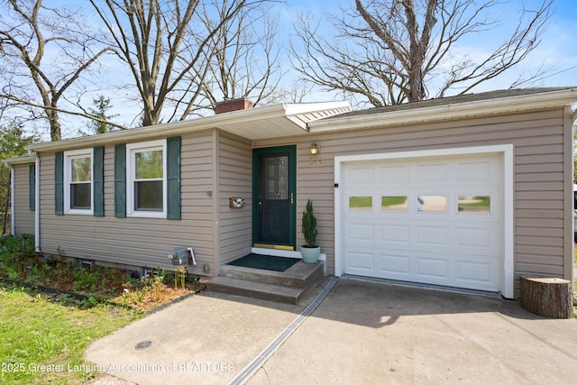 single story home with a garage, a chimney, and driveway