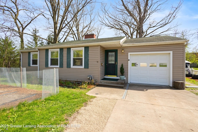 view of front of house featuring concrete driveway, fence, a chimney, and a garage