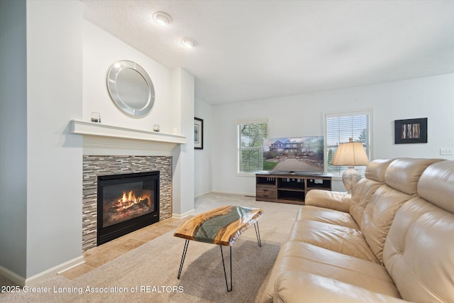 living area with a fireplace, carpet flooring, and baseboards