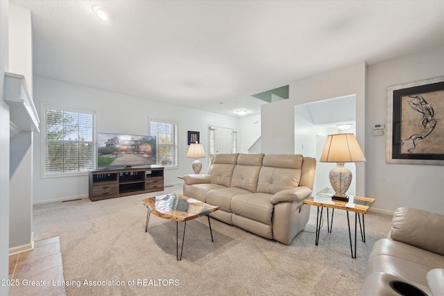 carpeted living room featuring baseboards