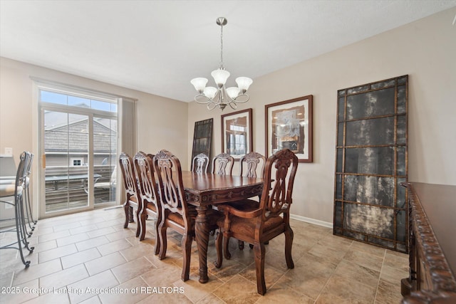 dining space featuring light tile patterned floors, an inviting chandelier, and baseboards
