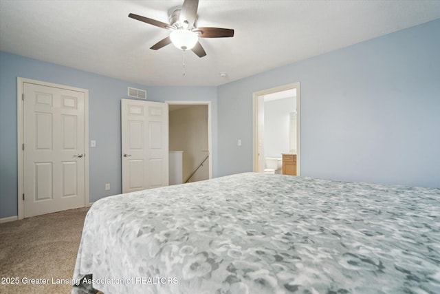 bedroom with ensuite bathroom, carpet flooring, ceiling fan, and visible vents