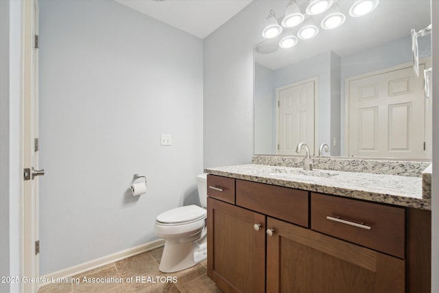bathroom featuring baseboards, toilet, tile patterned flooring, and vanity