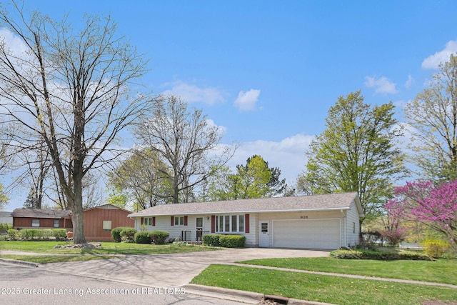 ranch-style house featuring a garage, driveway, and a front yard