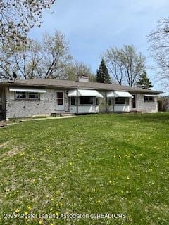 back of property with a lawn