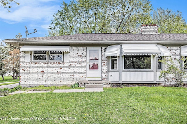 601/603 Farmstead Ln, Lansing, MI 48917 - view of front of house featuring a front lawn and a chimney
