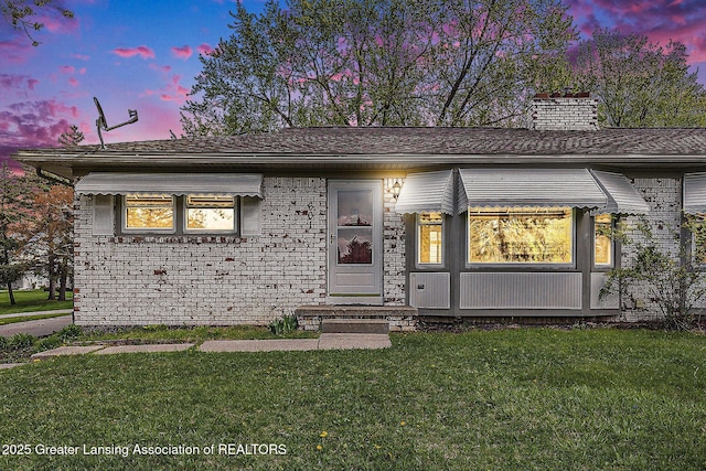 601/603 Farmstead Ln, Lansing, MI 48917 - single story home featuring a lawn and a chimney