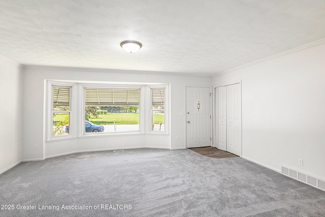 601/603 Farmstead Ln, Lansing, MI 48917 - empty room with baseboards, crown molding, visible vents, and carpet