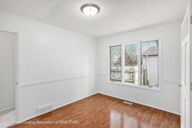 601/603 Farmstead Ln, Lansing, MI 48917 - empty room with wood finished floors and baseboards