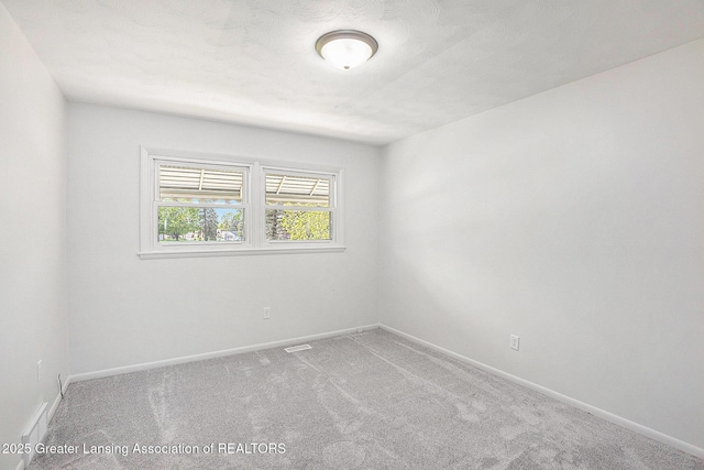 601/603 Farmstead Ln, Lansing, MI 48917 - carpeted empty room featuring baseboards