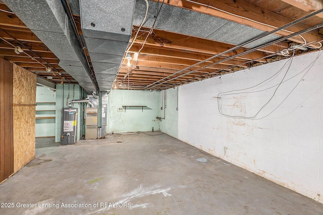 601/603 Farmstead Ln, Lansing, MI 48917 - unfinished below grade area with heating unit, water heater, and concrete block wall
