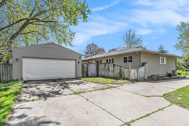 601/603 Farmstead Ln, Lansing, MI 48917 - view of side of property featuring fence, an outdoor structure, a garage, and a chimney