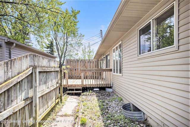 601/603 Farmstead Ln, Lansing, MI 48917 - view of home's exterior with a wooden deck and fence