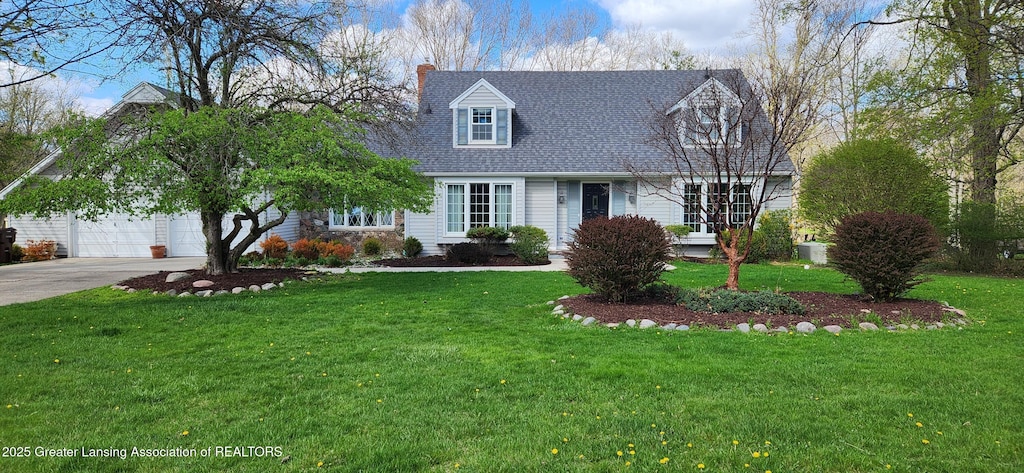 cape cod-style house with a front yard, a shingled roof, a chimney, concrete driveway, and an attached garage