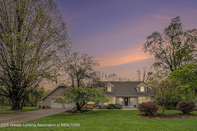 6528 Old River Trl, Lansing, MI 48917 - cape cod home with a lawn, driveway, and an attached garage