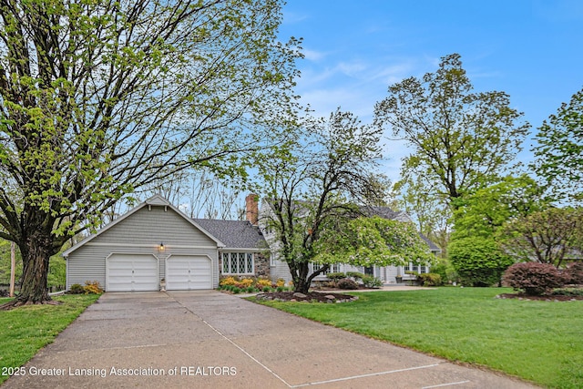 6528 Old River Trl, Lansing, MI 48917 - ranch-style home featuring concrete driveway, a front yard, a chimney, and a garage