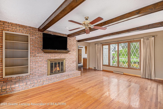 6528 Old River Trl, Lansing, MI 48917 - unfurnished living room featuring a baseboard radiator, ceiling fan, a brick fireplace, and wood finished floors