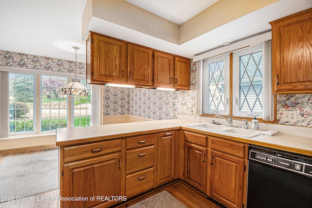 6528 Old River Trl, Lansing, MI 48917 - kitchen featuring brown cabinetry, black dishwasher, and a sink